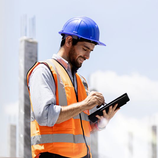 Site Manager is entering data about the site using a tablet.