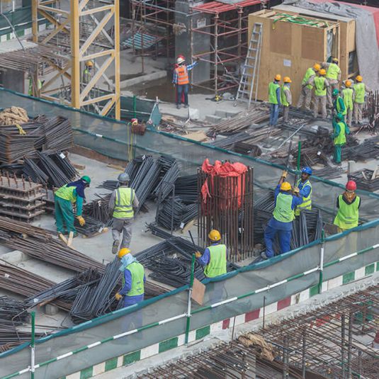 Industrial plant construction: Construction site with many construction workers at work.