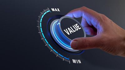 Digital supply chain: Hand turns knob labeled VALUE.