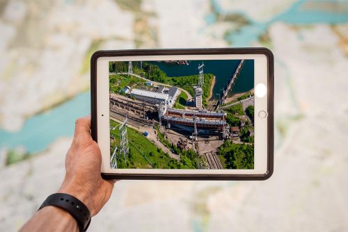 construction project documentation, tablet with photo of an industrial construction site
