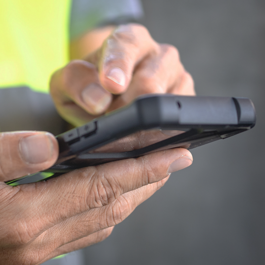Robust cell phone in the hands of a construction worker.