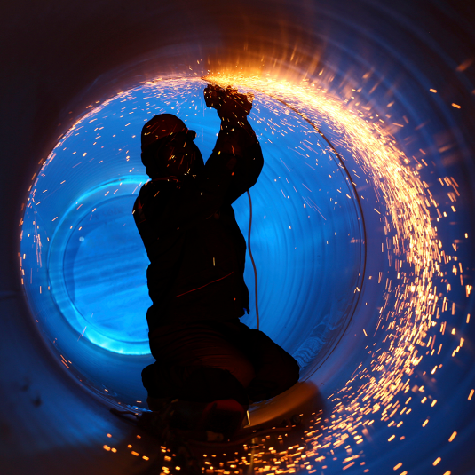 Prefabrication of pipeline: Worker is welding pipes.