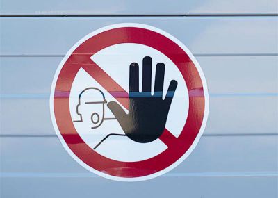 Stop sign - construction worker holds up hand.